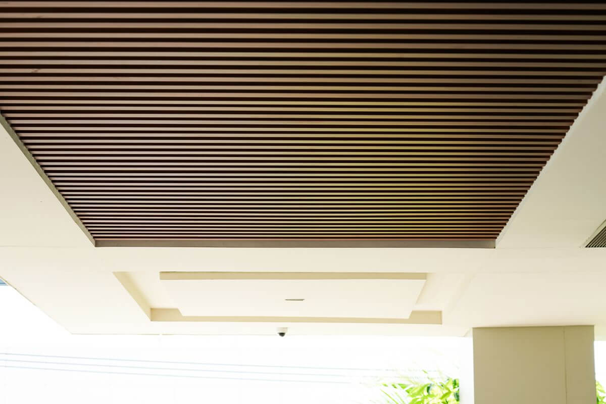 Wood slat ceiling baffling installed in a modern interior, supporting acoustic control and visual structure